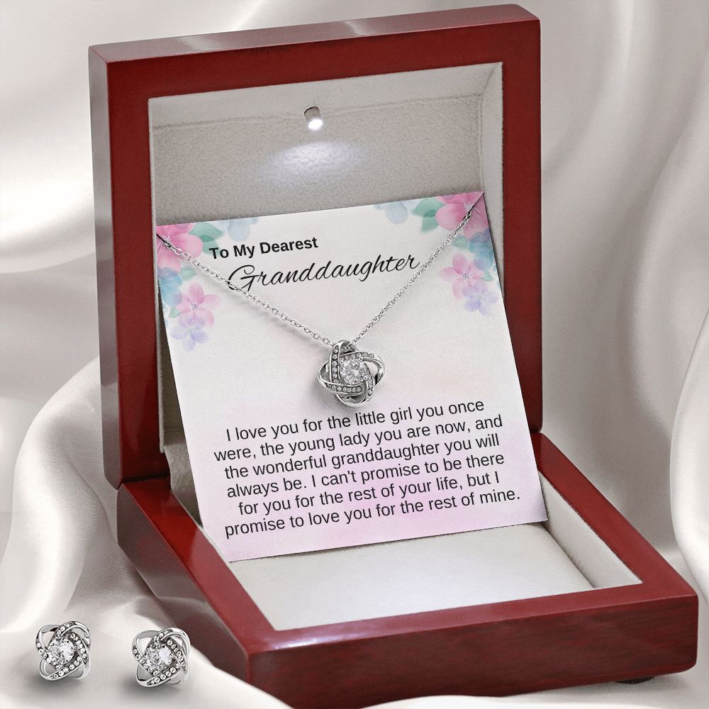 love knot necklace for granddaughter from grandma, grandpa or grandparents. it comes with a heartfelt message that reads, " I love you for the little girl you once were, the young lady you are now, and the wonderful granddaughter you will always be. I can't promise to be there for you for the rest of your life, but I promise to love you for the rest of mine. It is in a mahogany style box with led lights